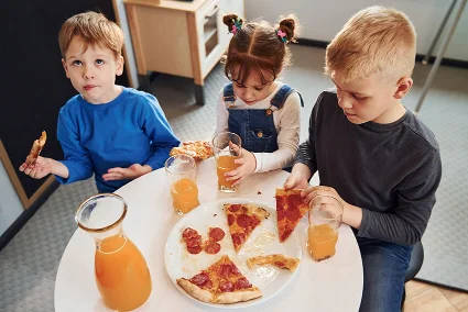 Kids relishing pizza